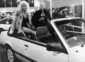 Swimming Costumes Prints: Two models pose in the backseats of the new soft top Cavalier on the Vauxhall General