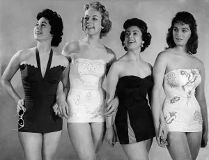 Four models wearing one piece swimsuits. March 1955 P018066