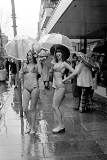 Models Wendy and Jackie seen here modeling the latest in swimwear on a wet Oxford Street