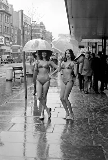 Models Wendy and Jackie seen here modeling the latest in swimwear on a wet Oxford Street