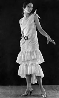 A modern gown reminiscent of the eighties in ivory faille with buckles of jade