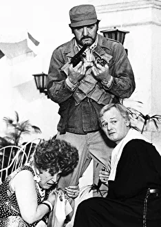Guns Prints: Molly Sugden actress inthe film version of Are You Being Served with John Inman holding