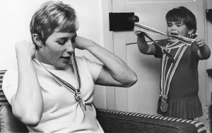 For a moment Alison Rand displays a touching lack of awe for the Olympic medals that put