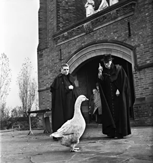 Monsignor Dunne and his pet goose Victor outside St Gregorys church, Preston