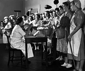 00001 Prints: Mops and brooms stand to attention. Institute of Houseworkers in Croydon where