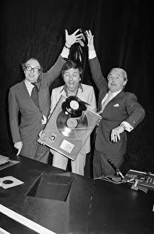 Morecambe and Wise present Des O Connor with a golden disc to mark 100000 sales of