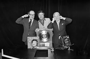 Morecambe and Wise present Des O Connor with a golden disc to mark 100000 sales of