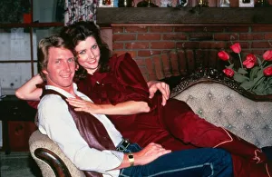 Morgan Brittany actress July 1983 sitting on couch with her husband