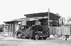 Caribbean Prints: A Morris Oxford undergoing repairs at a auto repair garage off the Spanish Town Road