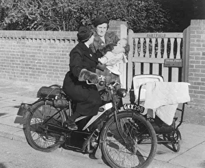 Midwife Prints: A mother stops district nurse Lily Rands on her bicycle to seek advice for her little