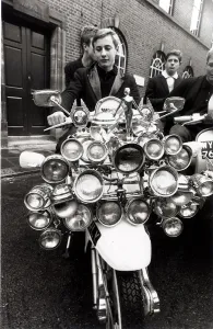 Motor Cycles John Rogers a petrol pump attendant shows of his Scooter Scooter with