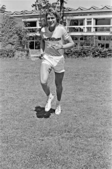 00930 Collection: Motor Racing Driver James Hunt jogging and smiling to the camera