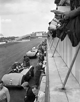 Motor Racing at Silverstone: Spectators on the grand stand balcony get a close up view as