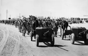 Moving up to the front line. New Zealand infantry marching through the choking sand of