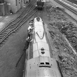 Rail Prints: Mr Alan Pegler and his crew of volunteers pictured cleaning The Flying Scotsman Engine