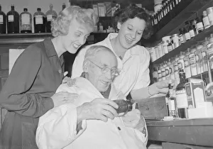 Mr Arthur Lawson 94 year old chemist seen here at work with his assistants at his