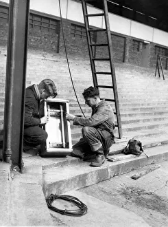 Illumination Prints: Mr C Urquhart and Mr A Moody working on a buzz bar chamber at the beginning of works