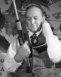 00087 Prints: Mr Charles Wade looking at the new motorised fishing reel which can be used by one armed