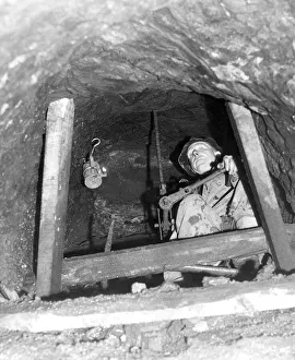 Drilling Prints: Mr. Edwin Rutherford, 58, is seen using a hand drill in a vertical tunnel 20 feet above