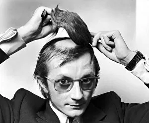 00302 Collection: Mr Graham George attaching a hair piece to the shaved bald patch on top of his head