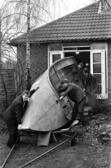 Mr Henry Fowler (left) enlists the aid of some friends to help him to take the boat out
