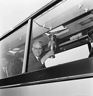 President Prints: Mr. T V Williams, President of Liverpool Football Club, showing off the trophy brought