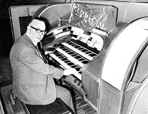 Mr. Wilf Donnelly of the Theatre Organ Club seated at the organ of the Odeon
