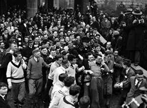 University Prints: Mr Winston Churchill is carried by students at Bristol University. December 1929