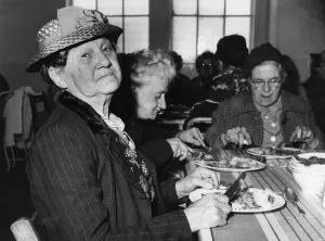 00171 Prints: Mrs Agnes Efferman, from Marion Street, Splott, Cardiff tucks into her one