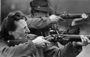 Firing Prints: Mrs. Bell is seen firing a British Army piece called Brown Bess