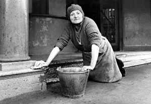 Mrs. Bella Pyle cleaning the steps at Stanleys Pavilion Cinema which has been empty