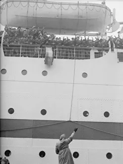 Mrs Buggins seen here waving off her son as the troopship Dunera sails for the far east