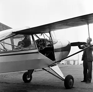 00526 Prints: Mrs Diana Freeman from Headcorn, Kent explains the controls of her Auster aircraft wile