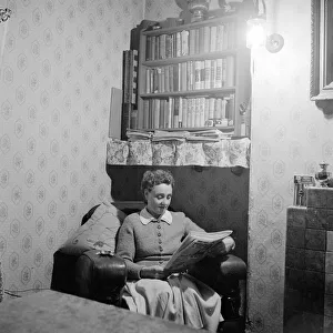 Mrs Dorothy Mead who still lights her house with gas lamps seen here reading her