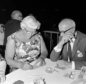 00115 Prints: Mrs Fielder enjoys a night out playing bingo at Maida Vale. 9th August 1961