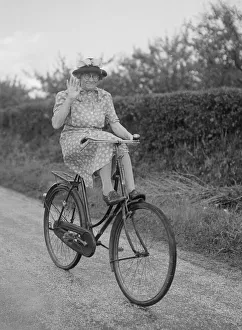 Mrs Hilda Baker seen here coasting downhill on her bicycle with her feet up on the front