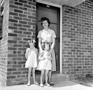Mrs. Kirby and her daughters, Carol, 5, and Sandra, 4, outside their council house today