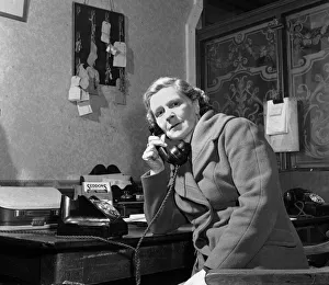 00099 Prints: Mrs Louiza Gunn of Kettering, Northamptonshire speaking on the telephone to her daughter