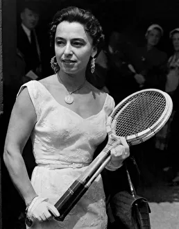 Rackets Prints: Mrs. Marie Weiss of Argentine, wearing a white satin dress