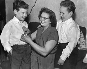 00077 Collection: Mrs. Mary Smalley of Burley, Lancs, with her two sons, Terry (aged 6) on the left