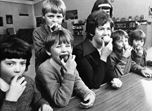 Apples Prints: Mrs Peta Syron munchesd on an apple with children at Simonside First School