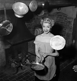Mrs Richard Heane tossing a pancake on Shrove Tuesday 1951. February 1951 B608 -003