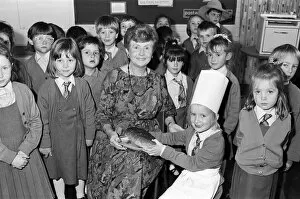 00705 Collection: Mrs Rita Manchester receives a loaf of bread from six-year old Angela Chapman after a