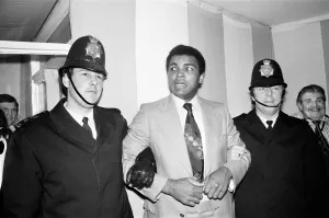 Muhammad Ali under friendly arrest of two London Police officers who were at the training