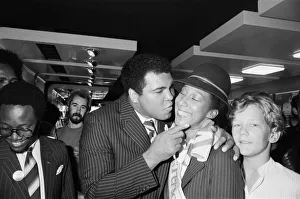 Kiss Prints: Muhammad Ali gives a British Airways hostess a kiss on his visit to Birmingham