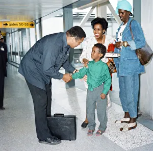 Ladies Prints: Muhammad Ali at Heathrow Airport shaking a young boys hand. 15th October 1989
