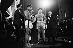 Muhammad Ali (left) and Brian London shake hands at the weigh-in ahead of their