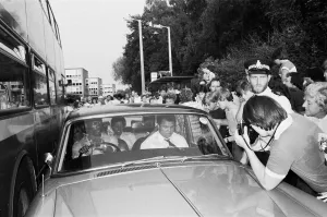 Muhammad Ali in the passenger seat makes his way through Coventry mobbed by fans