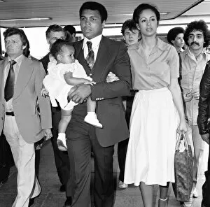Images Dated 10th January 2013: Muhammad Ali with second wife Veronica and their baby girl Hana arriving in England