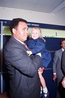 Muhammad Ali seen here with four year old Hannah Clarke during a book signing session